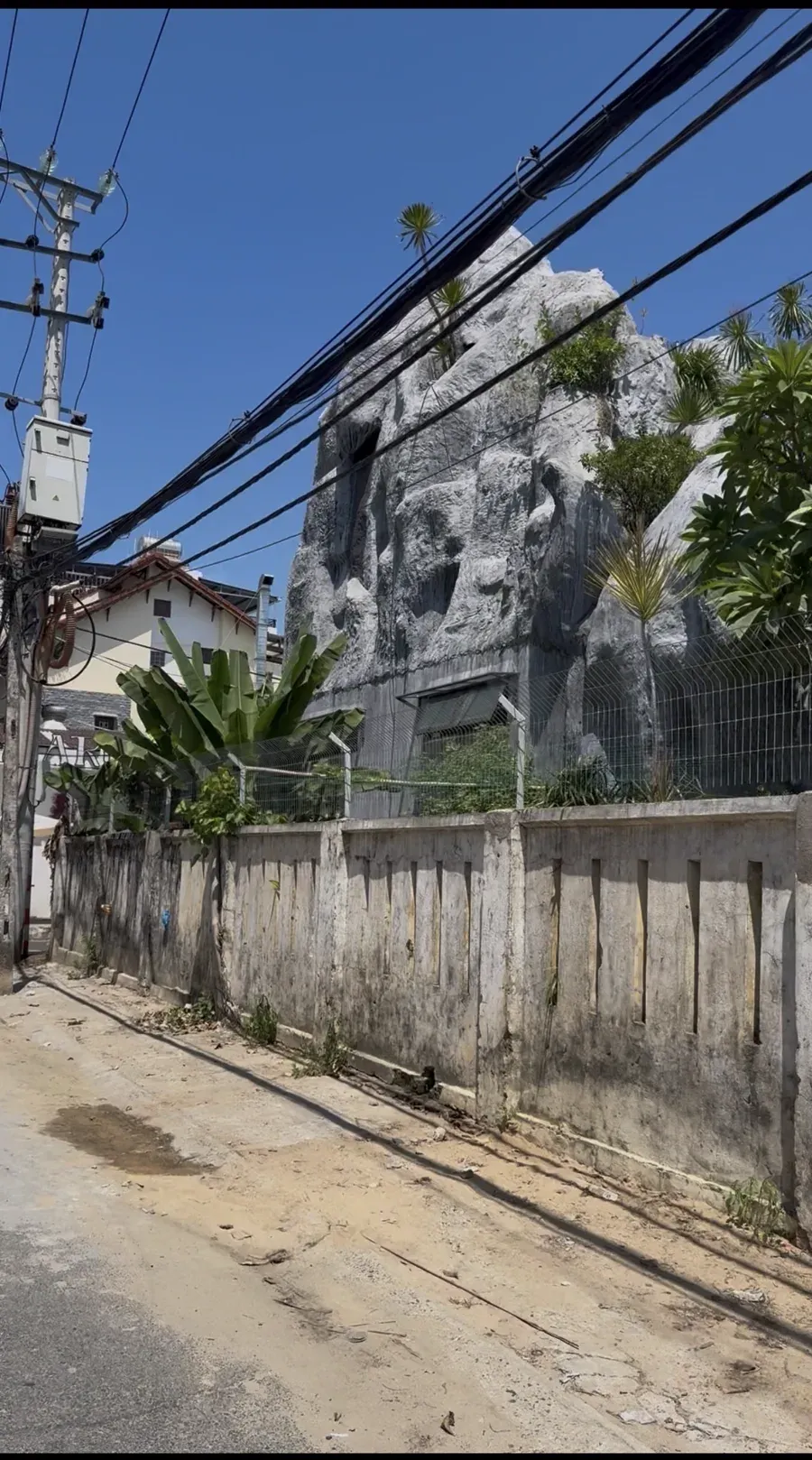 The church’s big grey rock at the entrance to our alley