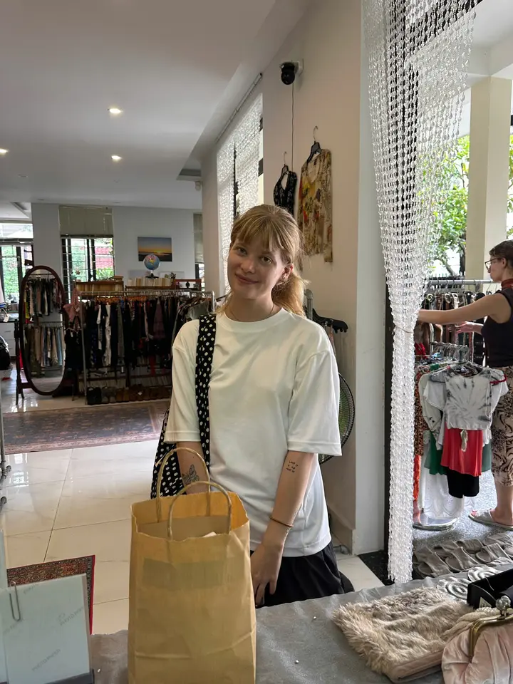 Happy Yen May Vintage customer holding a shopping bag