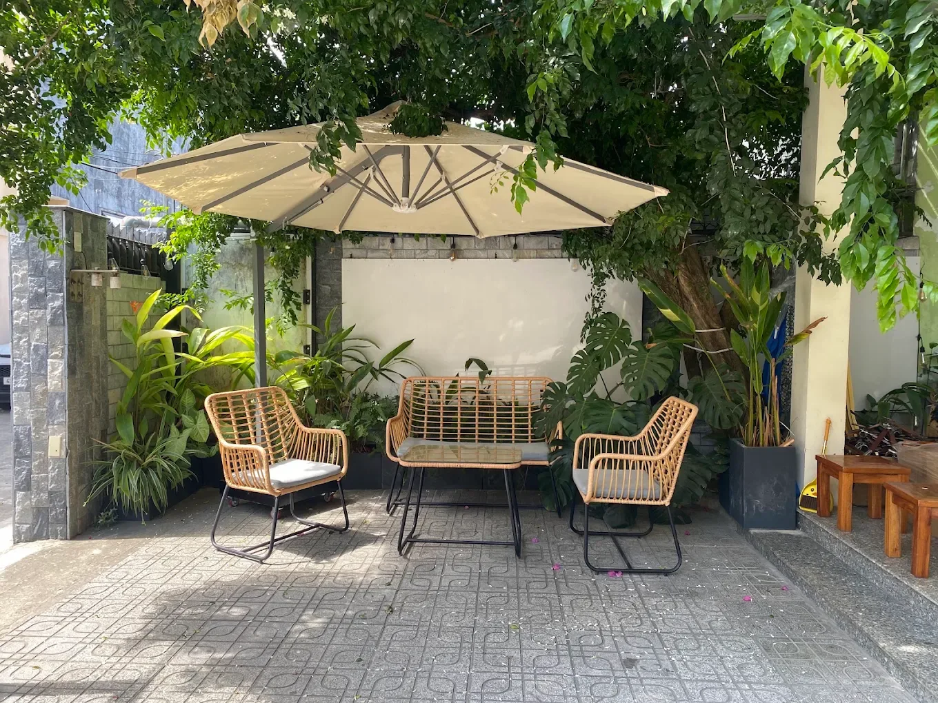 Shaded rattan seating outside Yen May Vintage in Da Nang